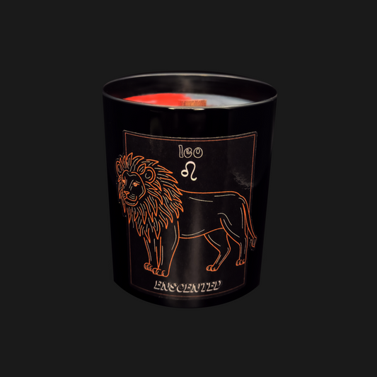 A black candle with a red tint on top, featuring an illustration of a lion and the text 'LEO FASCINATED'.